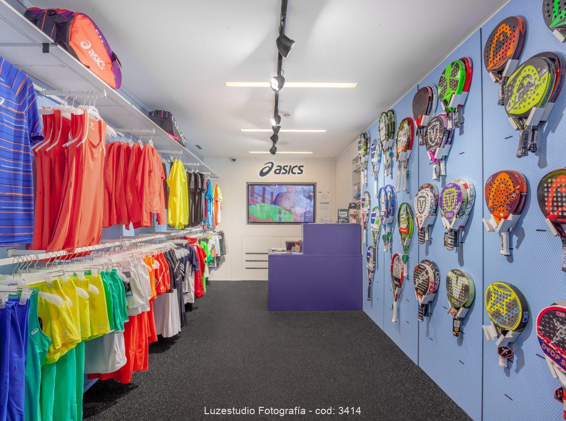 fotografía de interior comercial tienda asics con ropa deportiva y palas de padel en ciudad de la raqueta madrid